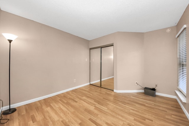 10555 Turtlewood Ct Unit 1510, Houston, TX 77072 - unfurnished bedroom with light wood-type flooring, a closet, and baseboards