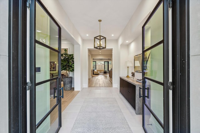 entrance foyer featuring recessed lighting, french doors, baseboards, and light tile patterned flooring