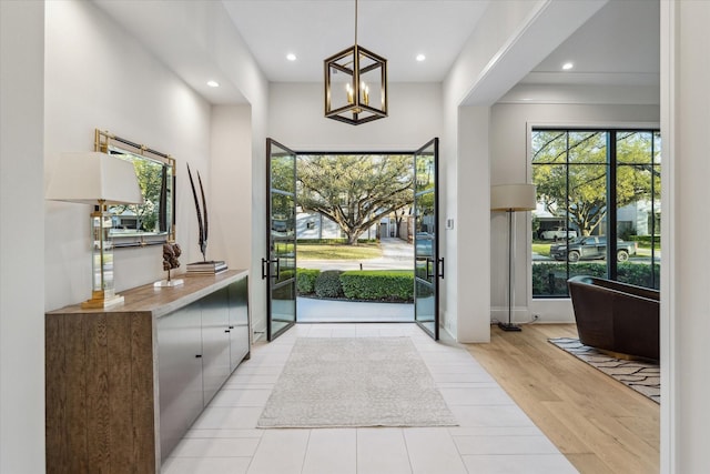 doorway to outside featuring an inviting chandelier, recessed lighting, and light wood-style floors