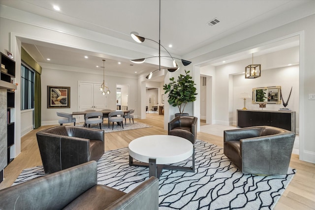 living room with recessed lighting, light wood-type flooring, baseboards, and visible vents