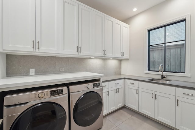 laundry room with recessed lighting, light tile patterned flooring, cabinet space, independent washer and dryer, and a sink