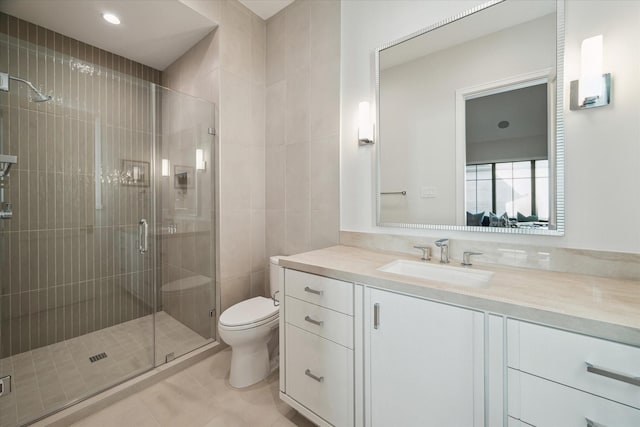 bathroom with vanity, toilet, a stall shower, and tile patterned flooring