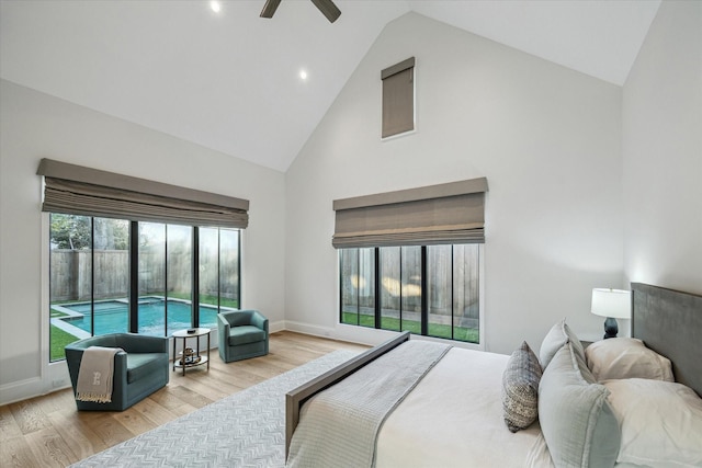 bedroom featuring high vaulted ceiling, access to exterior, wood finished floors, baseboards, and ceiling fan