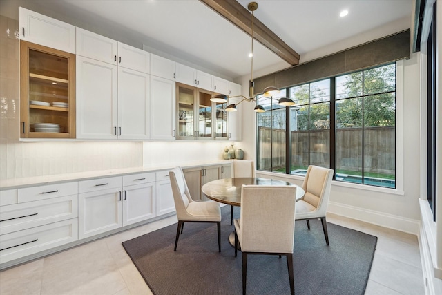 dining area with beam ceiling, light tile patterned floors, recessed lighting, and baseboards