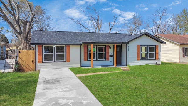 single story home with a front yard, fence, covered porch, and roof with shingles