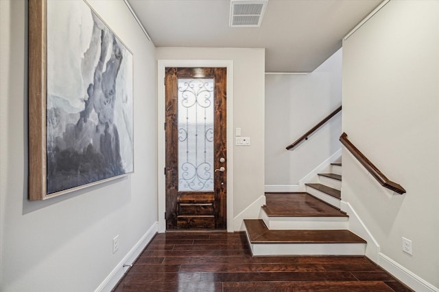 entrance foyer with visible vents, baseboards, wood finished floors, and stairs