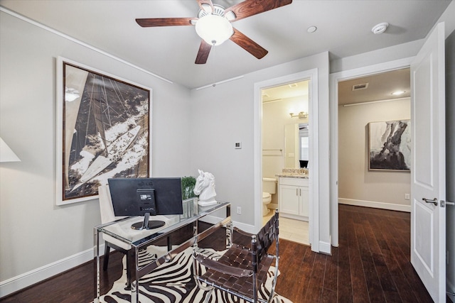 office area with visible vents, baseboards, and wood finished floors