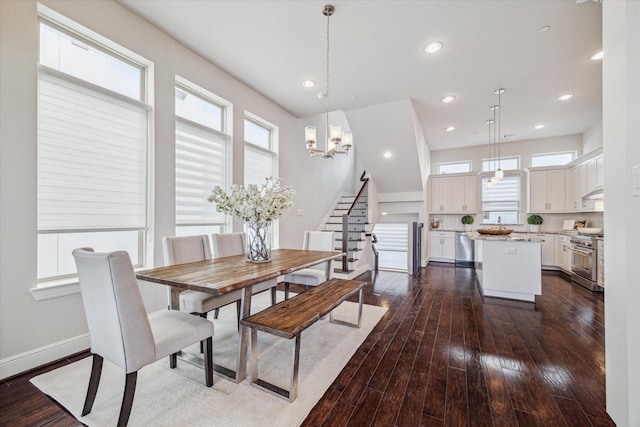 dining room with dark wood-type flooring, baseboards, stairway, recessed lighting, and a notable chandelier