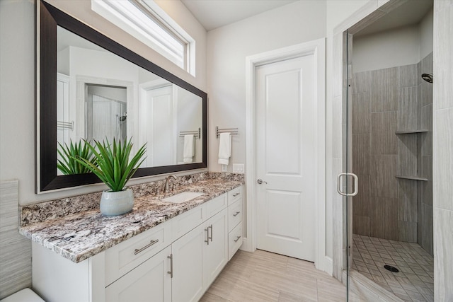 full bathroom with vanity and a shower stall