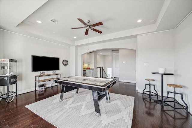 playroom with visible vents, ceiling fan, baseboards, hardwood / wood-style flooring, and arched walkways