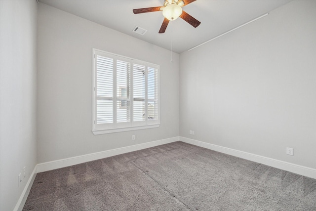 empty room with carpet, baseboards, visible vents, and ceiling fan