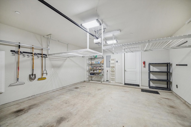 garage featuring electric panel and a garage door opener