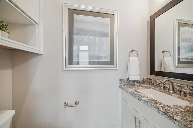 bathroom with toilet and vanity