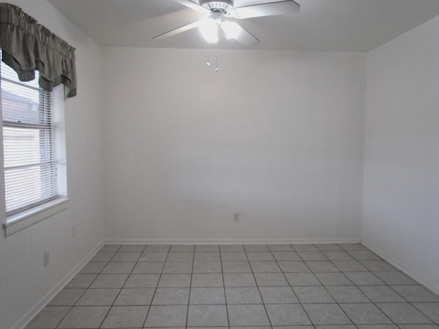 unfurnished room featuring light tile patterned floors, baseboards, and ceiling fan