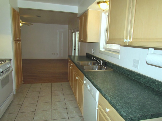 kitchen with a ceiling fan, a sink, dark countertops, white appliances, and light tile patterned floors