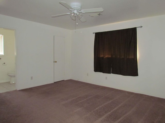 carpeted empty room featuring ceiling fan