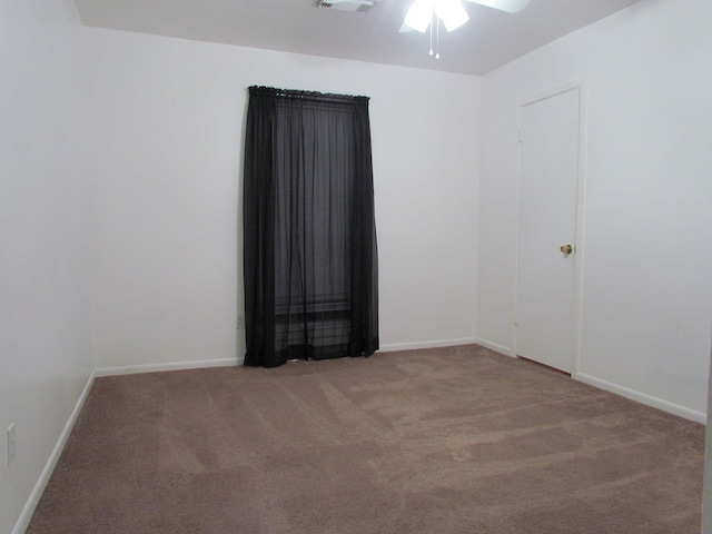 empty room featuring visible vents, baseboards, a ceiling fan, and carpet flooring