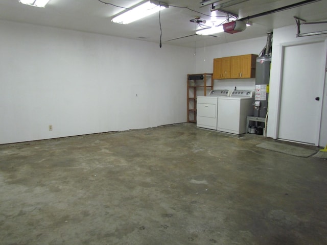 garage featuring gas water heater, a garage door opener, and washer and clothes dryer