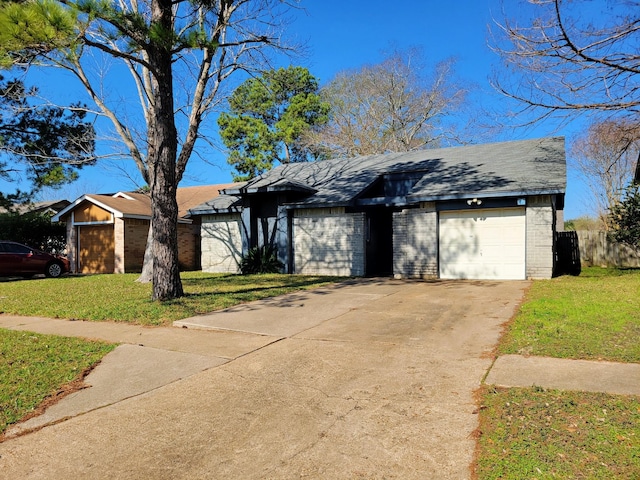 mid-century home featuring brick siding, a garage, concrete driveway, and a front lawn