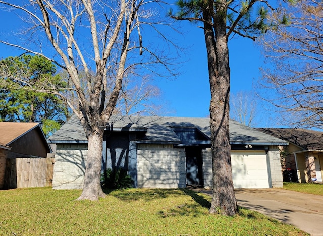 mid-century home with fence, concrete driveway, a front lawn, a garage, and brick siding