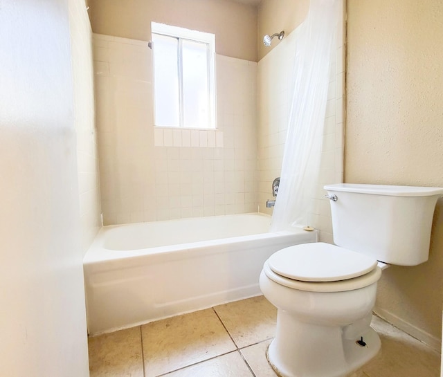 full bath with tile patterned flooring, toilet, and shower / bath combo