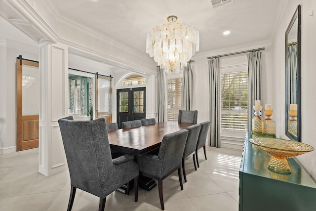 dining room featuring ornamental molding, a barn door, french doors, an inviting chandelier, and light tile patterned flooring