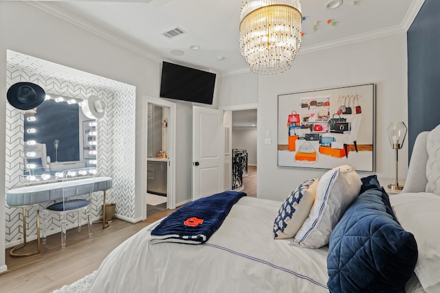 bedroom featuring visible vents, an inviting chandelier, wood finished floors, and crown molding