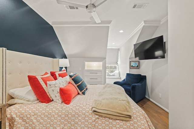 bedroom featuring visible vents, wood finished floors, baseboards, and ornamental molding