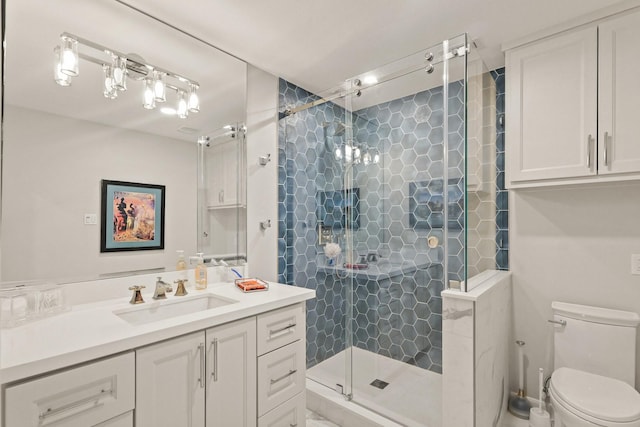 bathroom featuring a shower stall, toilet, and vanity