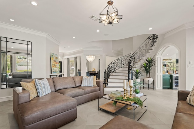 living area with stairway, beverage cooler, visible vents, an inviting chandelier, and a bar