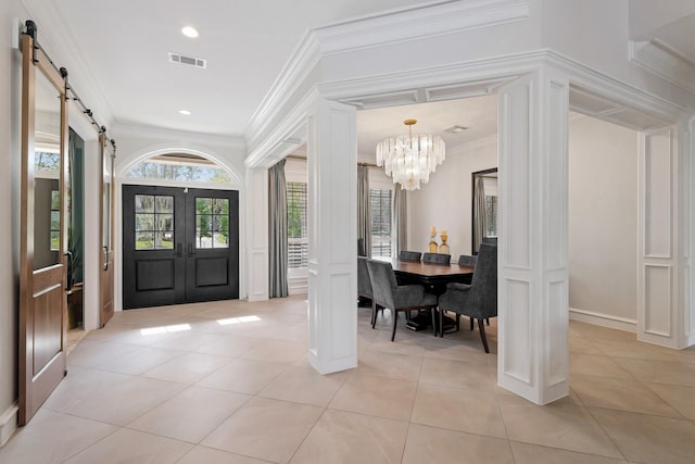 entrance foyer with visible vents, crown molding, a barn door, light tile patterned flooring, and a notable chandelier