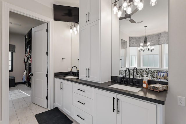 full bathroom featuring double vanity, visible vents, marble finish floor, and a sink