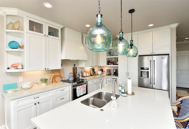 kitchen featuring premium range hood, open shelves, a sink, light countertops, and appliances with stainless steel finishes