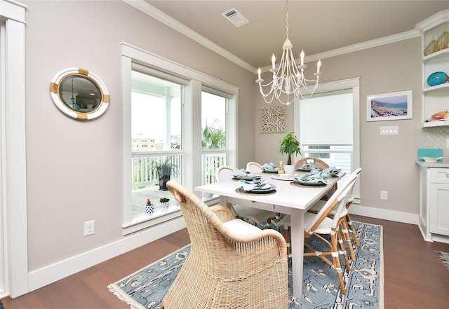 dining space with visible vents, dark wood-style floors, an inviting chandelier, crown molding, and baseboards