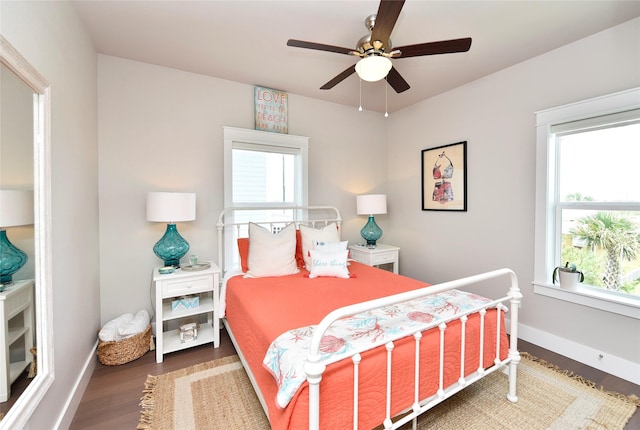 bedroom featuring a ceiling fan, baseboards, and wood finished floors