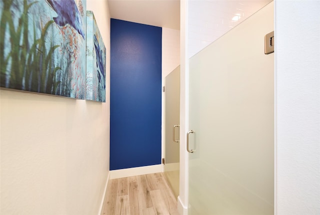 hall featuring wood finished floors and baseboards