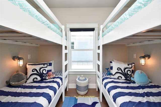 bedroom with wood finished floors and baseboards