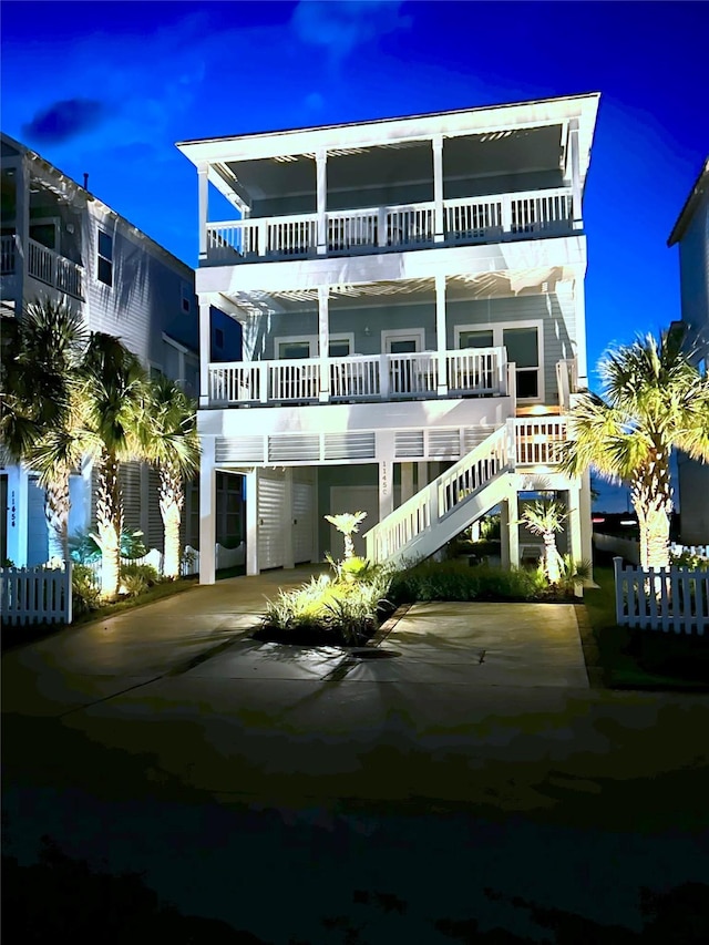 back of property featuring stairway and driveway