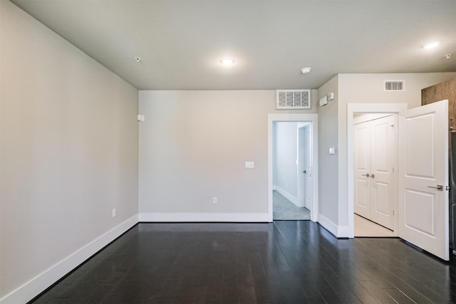 spare room featuring visible vents, recessed lighting, baseboards, and wood finished floors