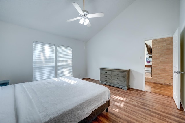 bedroom with high vaulted ceiling, wood finished floors, and a ceiling fan