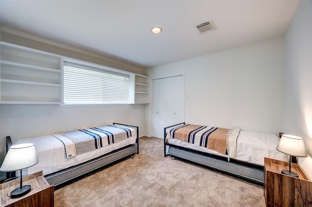 bedroom featuring a closet, carpet flooring, recessed lighting, and visible vents