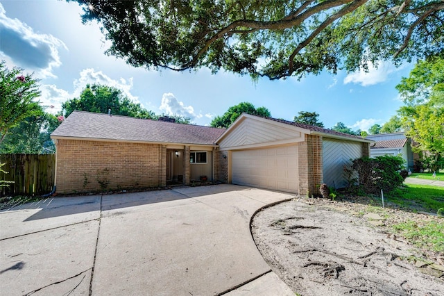 ranch-style home featuring fence, concrete driveway, an attached garage, a shingled roof, and brick siding