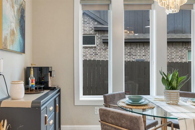 interior space featuring a chandelier and baseboards