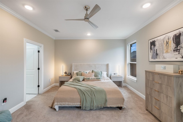 bedroom featuring visible vents, baseboards, light colored carpet, and crown molding