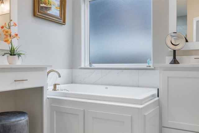 full bathroom featuring a bath and vanity