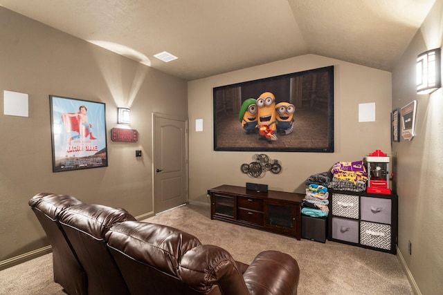 carpeted cinema with visible vents, lofted ceiling, and baseboards