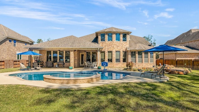 rear view of house with a yard, brick siding, a fenced backyard, and a patio area