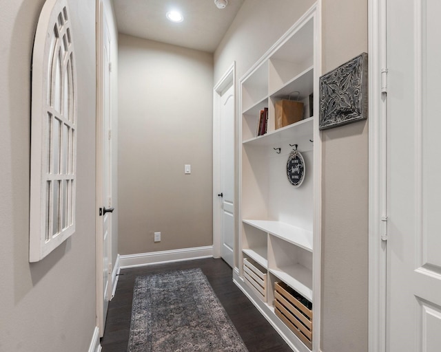 mudroom with dark wood finished floors, recessed lighting, and baseboards