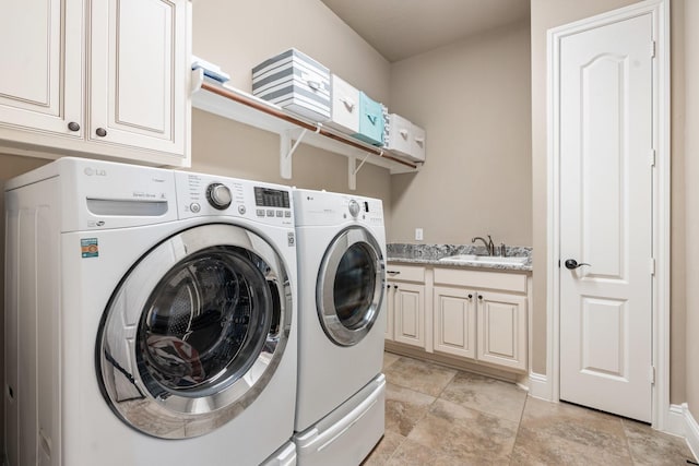 laundry room featuring cabinet space, washer and dryer, and a sink