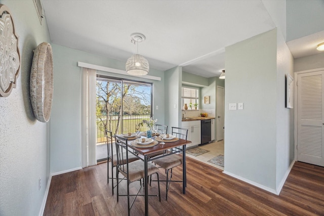 dining room with dark wood finished floors and baseboards